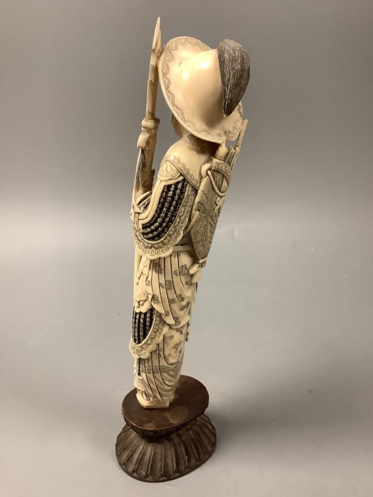 A Chinese ivory figure of Hua Mulan, early 20th century, height 26cm including wood stand